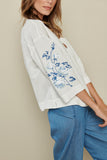 White tunic blouse with blue broderie